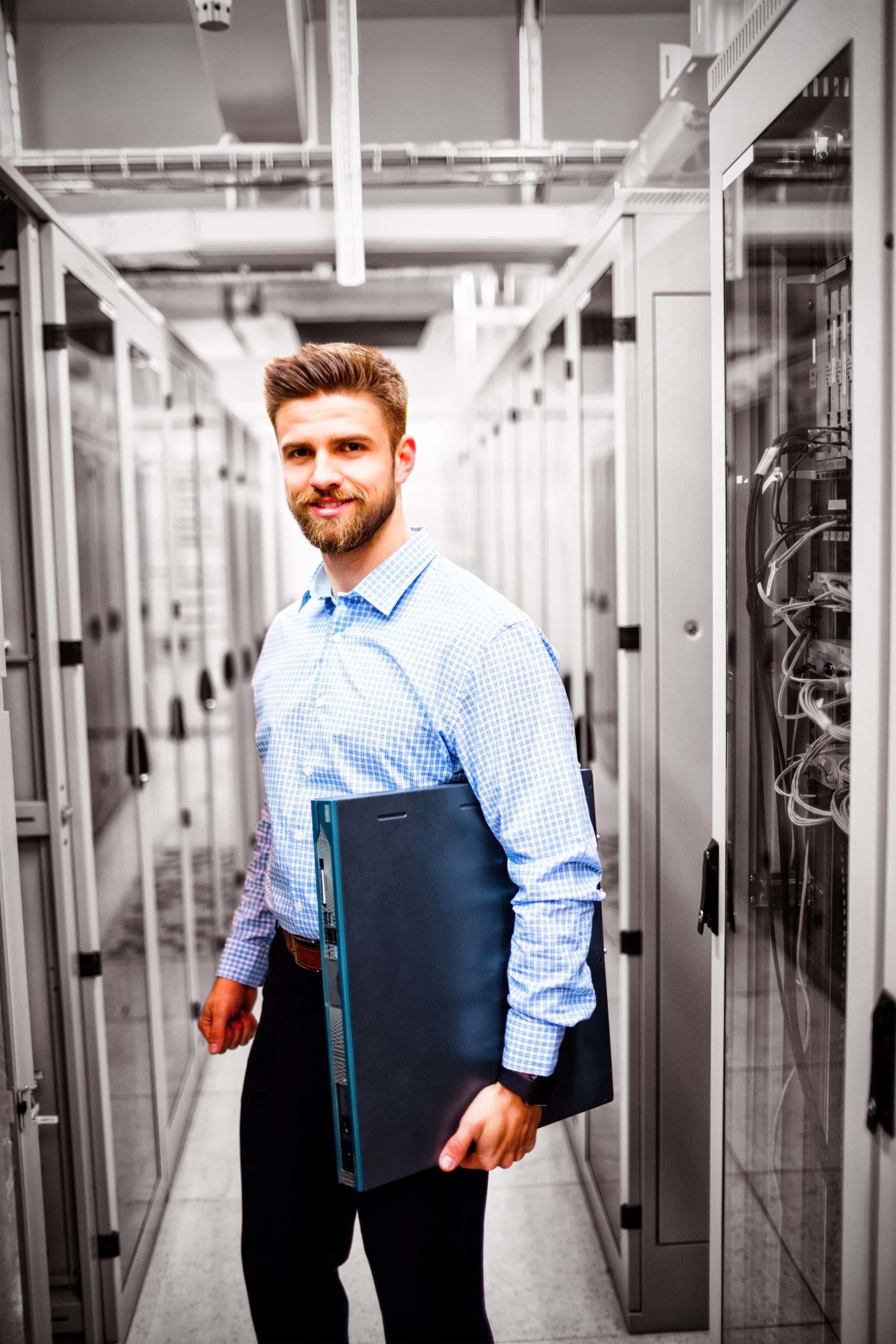 Portrait of technician holding a server in server room